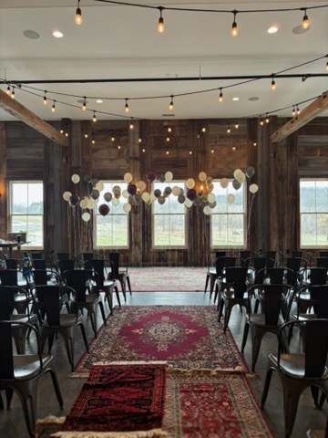 Wedding ceremony aisle with floating balloon clusters