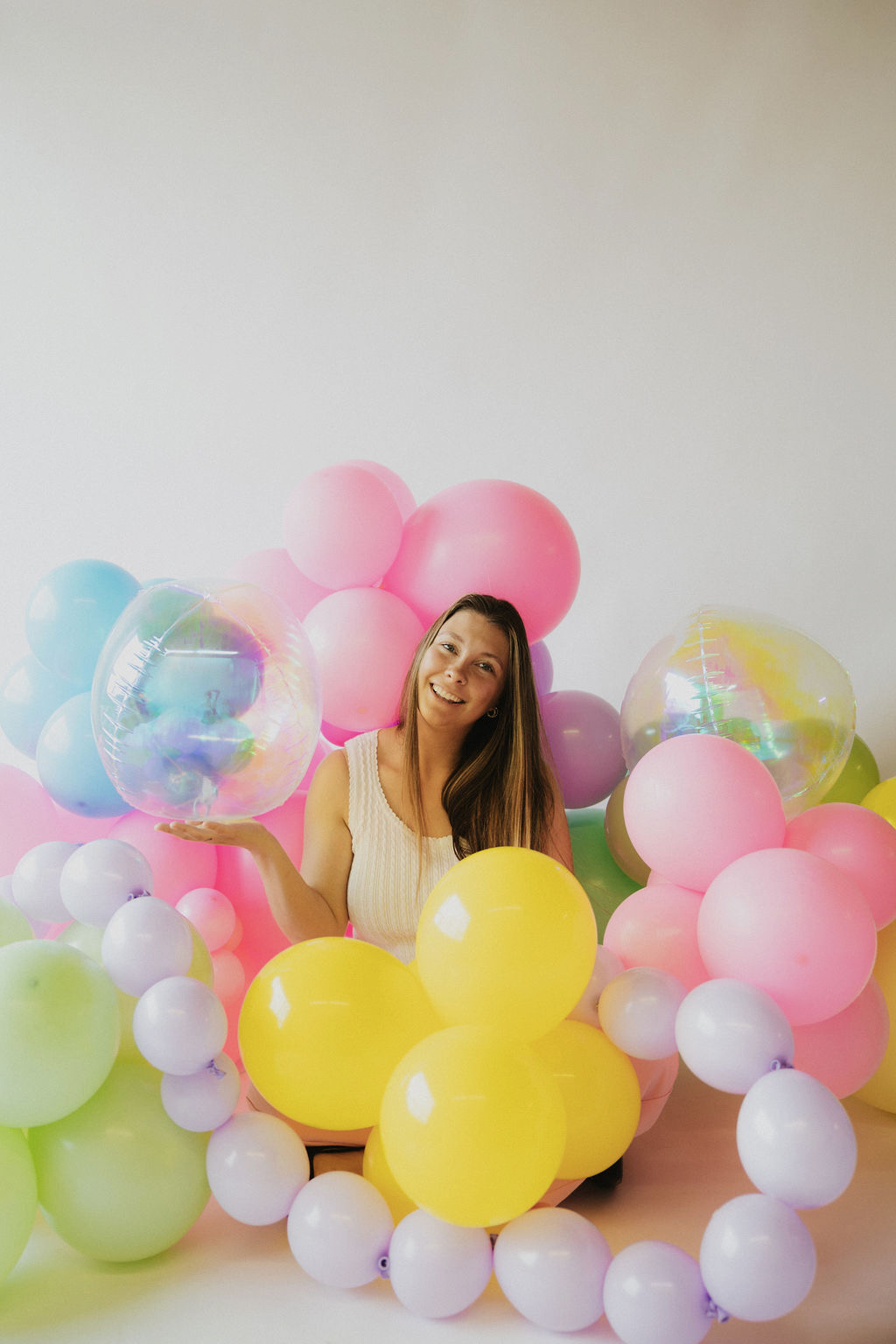 Jenni surrounded by her colorful balloon creations