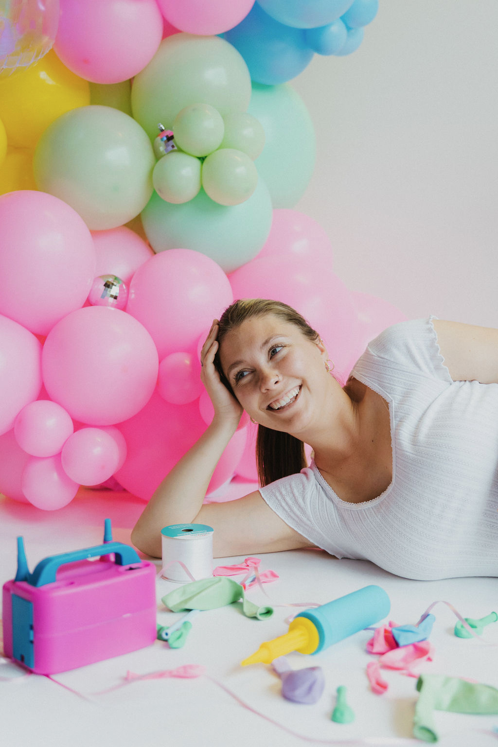 Jenni smiling beside her balloon pump and supplies