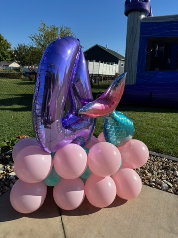 Mermaid 4th birthday balloon display with mermaid tail