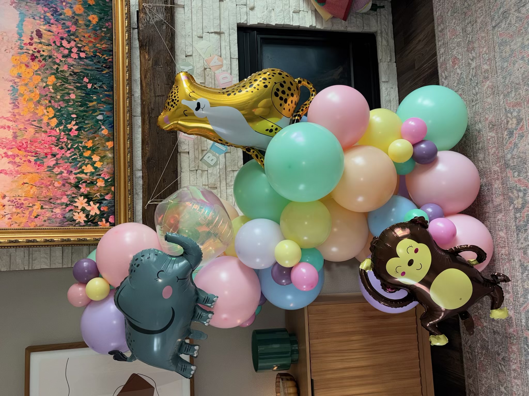 Safari-themed balloon arch with animal foil accents
