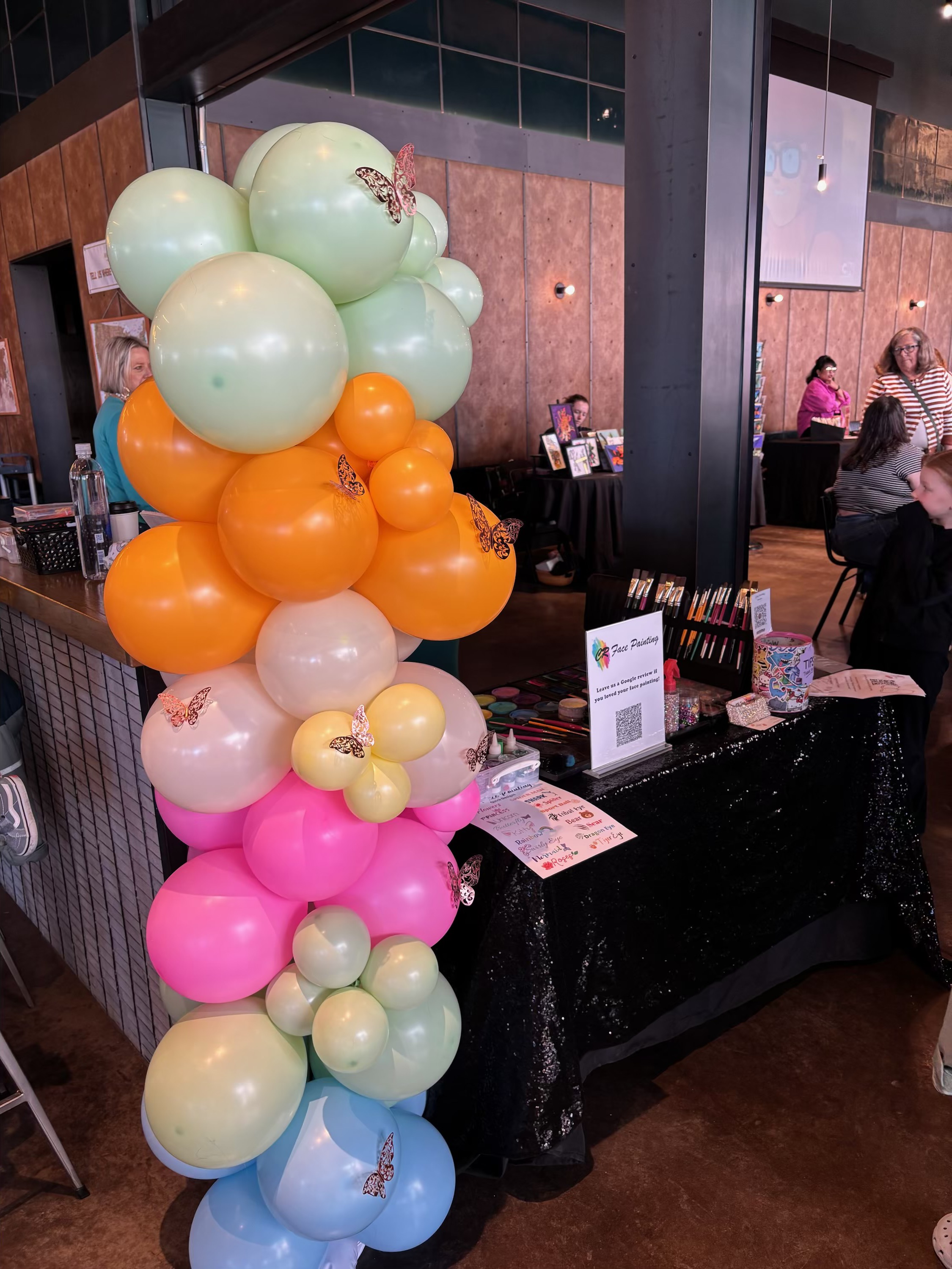 Pastel balloon garland styling an event vendor display